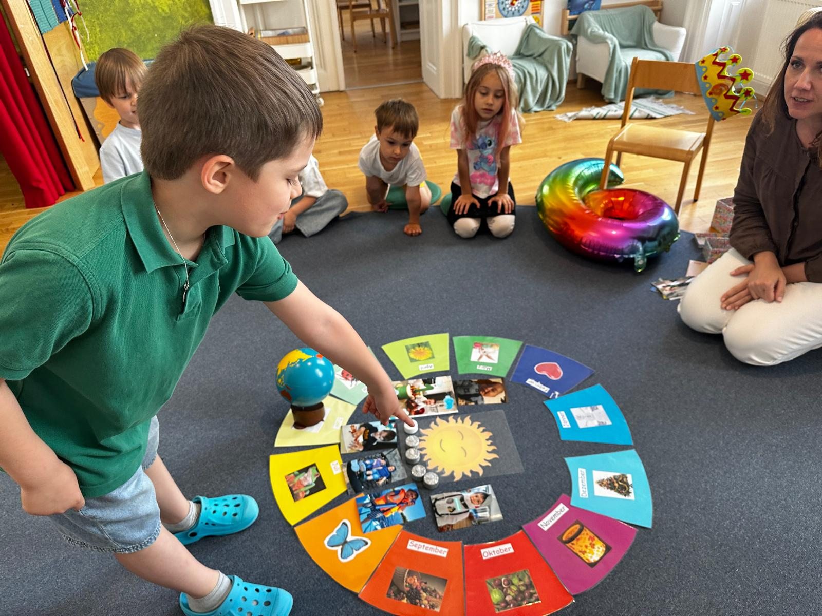 Children exploring a circle of seasons and pictures together