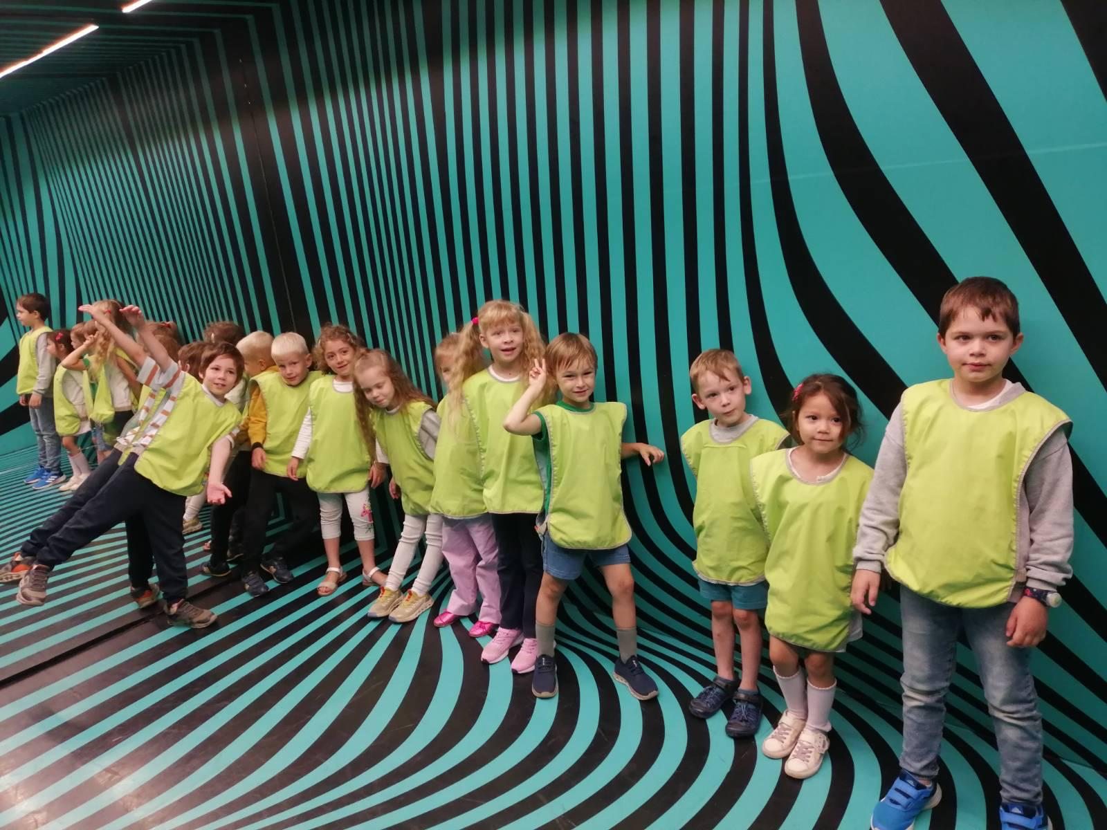 Children on an outing among black and turquoise optical patterns